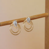 Lifestyle angled view of a set of Ripple Earring / Lab Pear Diamond pieces by Goldpoint Jewelry