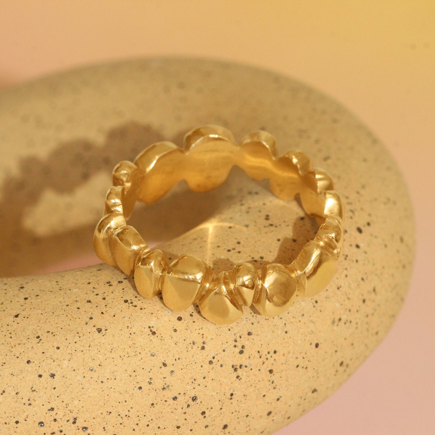 Lifestyle angled view of Ruins Wide Band in 14k yellow gold