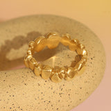 Lifestyle angled view of Ruins Wide Band in 14k yellow gold