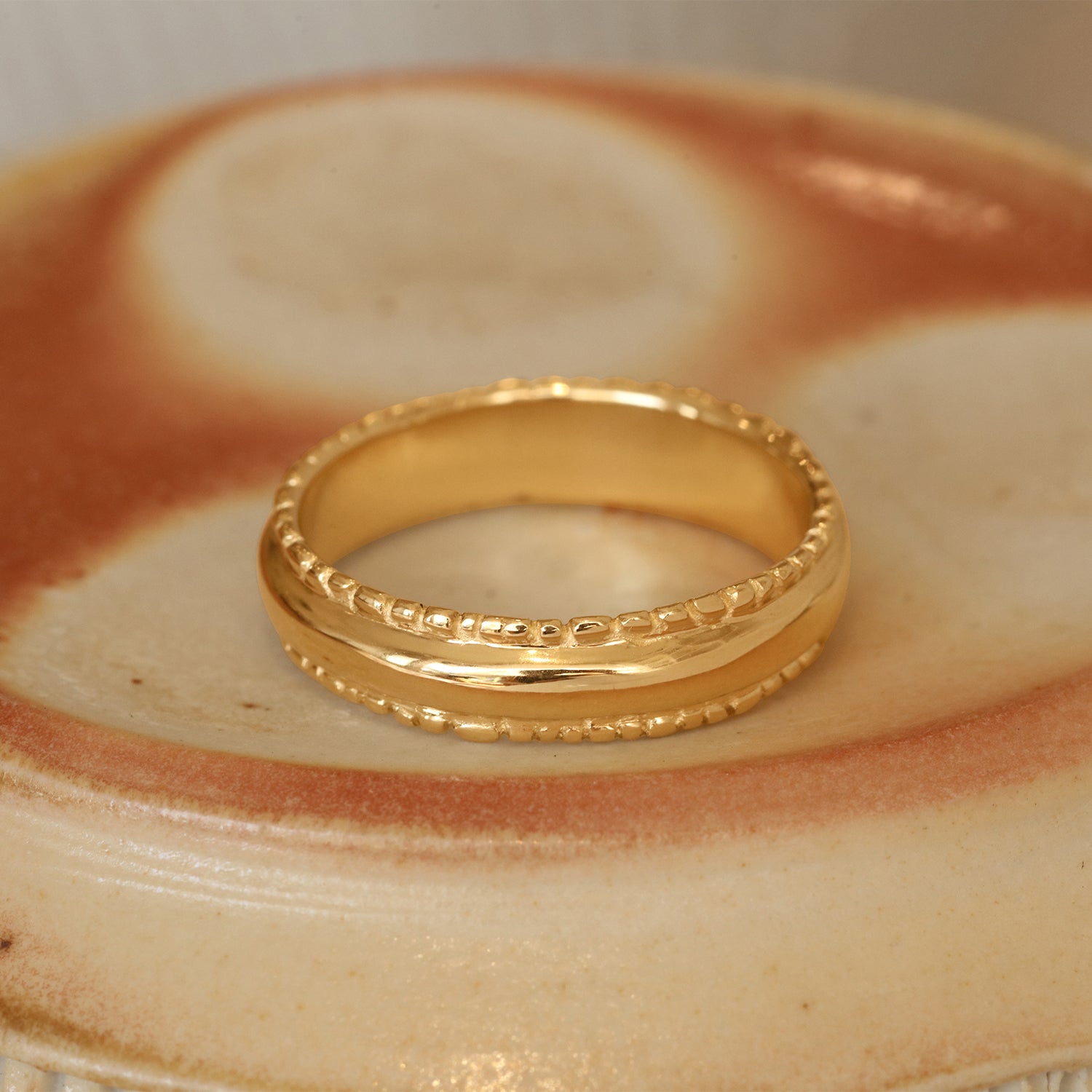Lifestyle angled view of Ruins Dome Band in 14k yellow gold