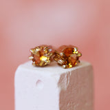 Lifestyle angled view of Talon Earring Round Citrine 5mm by Goldpoint Jewelry on a ceramic prop