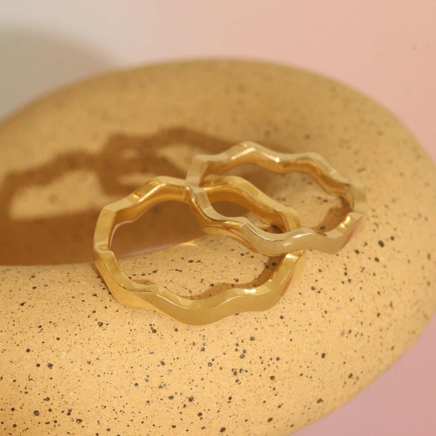 Lifestyle stacked view of Waves Band in 14k White Gold and Waves Band in 14k Yellow Gold