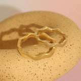 Lifestyle stacked view of Waves Band in 14k White Gold and Waves Band in 14k Yellow Gold