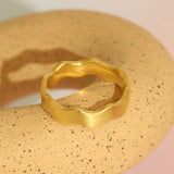 Lifestyle angled view of Waves Wide Band  in 18k yellow gold