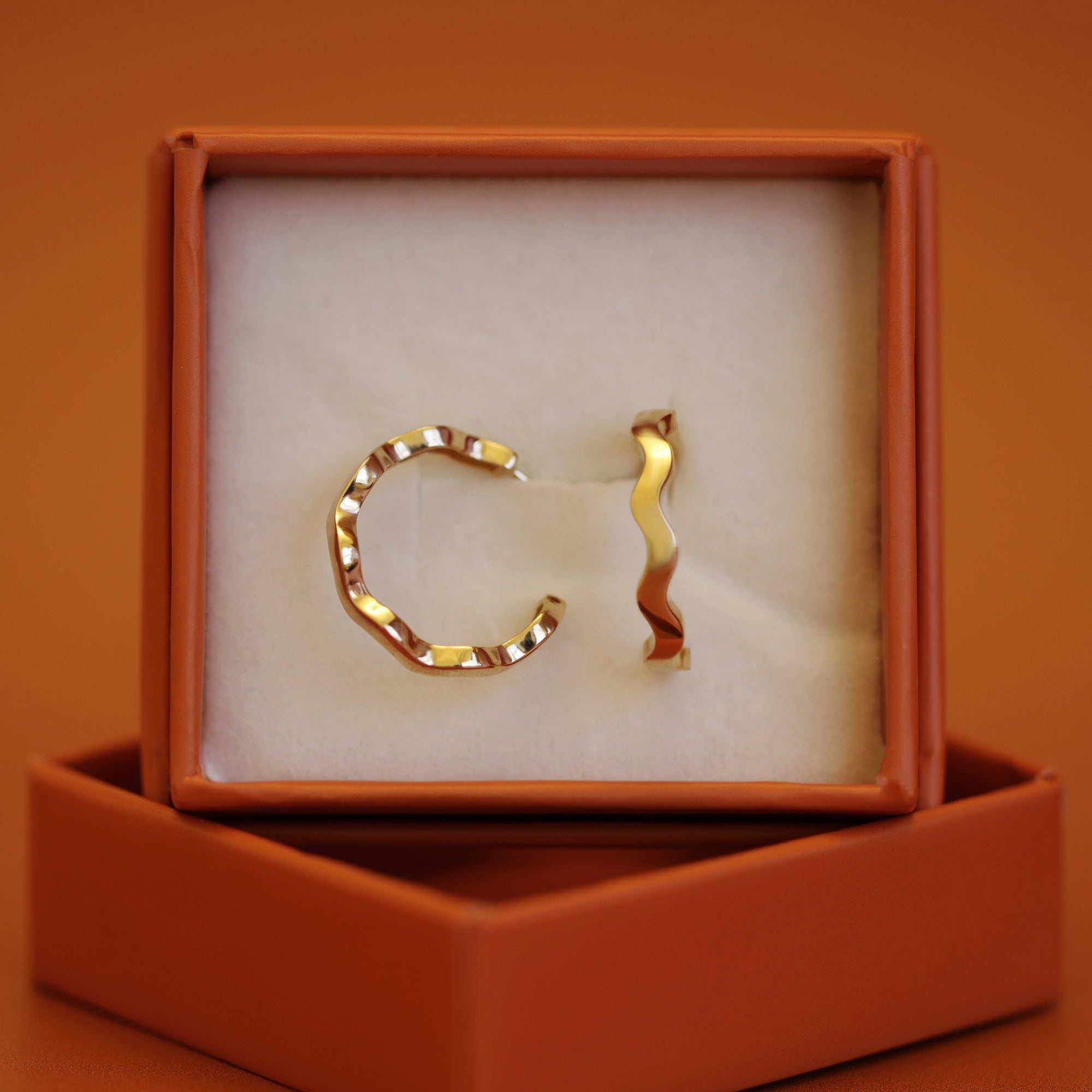 A gift box containing a set of Waves Hoop / Large pieces by Goldpoint Jewelry