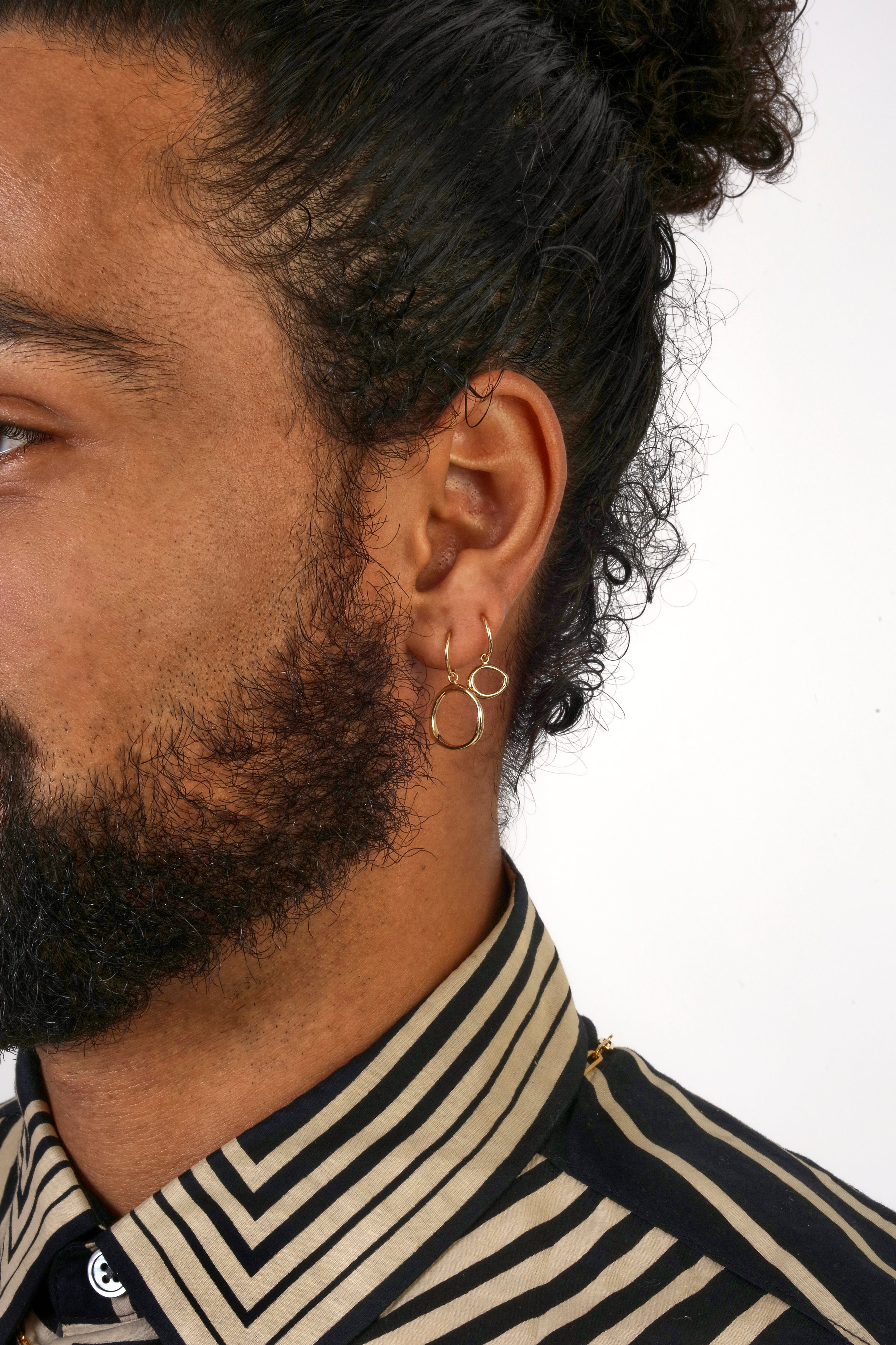 Model wearing Amorphous Charm / Small Circle on a hoop earring alongside Amorphous Charm / Large Circle on a hoop earring.