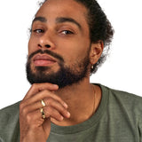 Model wears Waves Wide Band in 18k yellow gold on pinky finger by Goldpoint
