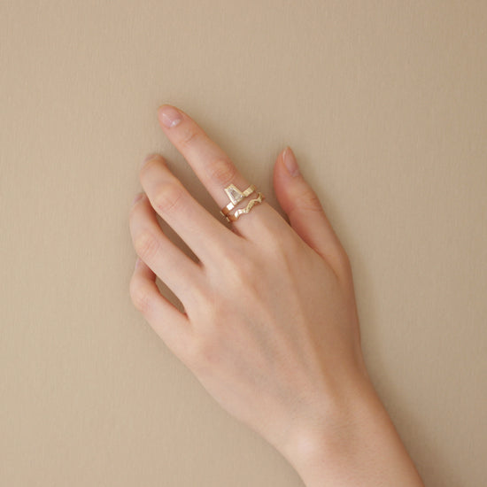 Model wearing engagement ring with Waves Band / Medium