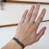 Model wearing Curve Flat Band / Wide on ring finger showing different angles of band