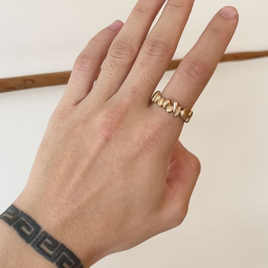 Model wears Ruins Wide Band in 14k yellow gold on index finger